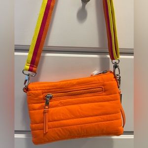 NWT Sondra Roberts clutch/crossbody. Beautiful orange color with vibrant strap